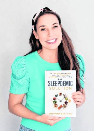 Erin Palinski-Wade holds her book.