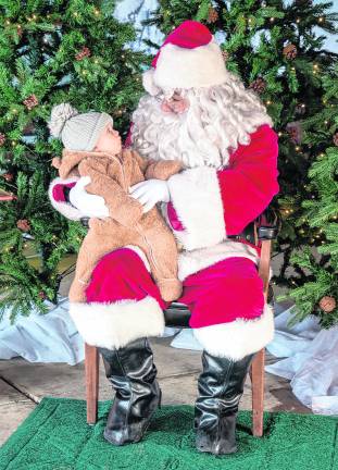 Chloe Trainor looks at Santa Claus.