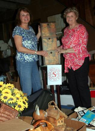 from left, Roberta Dyrsten, Sparta Woman's Club President, and Edwina Kirkowski, aco-chair of Trinket and Treasures, showing items for the October 7 event.