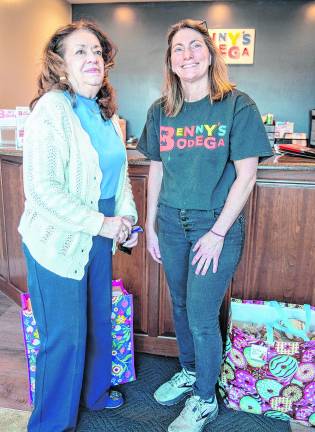 Connie Truncali delivers cookies to Shelly Ferguson, manager of Benny's Bodega.