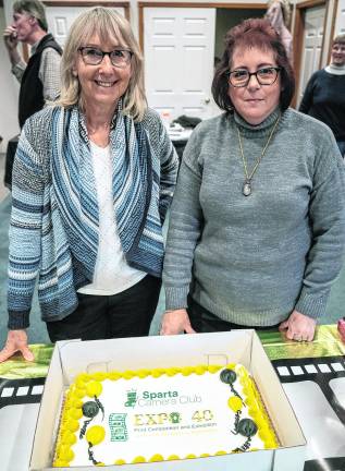 Marlene Milko and Cheryl Hederson-Brill look at the anniversary cake.