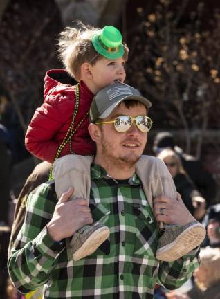 Kyle Whitehead of the Branchville Hose Company marches in the parade with his son Aiden, 3, on his shoulders.