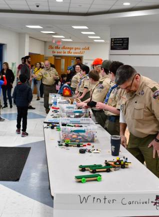 Boy Scouts display parts used for their Pinewood Derby.