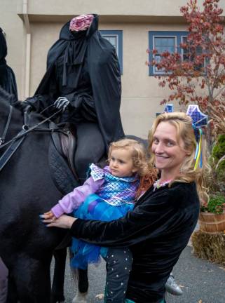 Ali Denamiel holds her daughter Evie next to the Headless Horseman.
