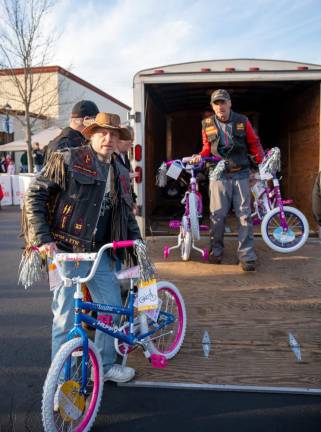 Members of the Warlocks Motorcycle Club, based in Hardyston, unload some of the toys, worth $10,000, that they donated to Toys for Tots. This is the third year that the group has raised funds for the project.