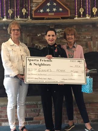 Presenting the donation to Ginnie Littell of Ginnie's House. (Photos provided)