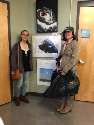 From left, Carolyn Galgano and her teacher, Christine O'Brien-Mase, standing on either aide of the winning photo of 'Wet Dog'