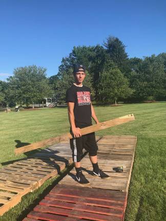 Tyler McGinnis begins building a walk-through tunnel for displaying information about homelessness.