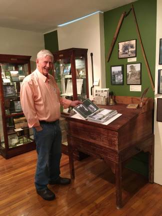 Museum Director Jack Clark shows binder full of Sparta history