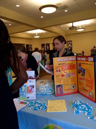 Tracey Mazzucco, from the Sussex-Warren Chronic Disease Coalition, educates about the importance of using sun screen.