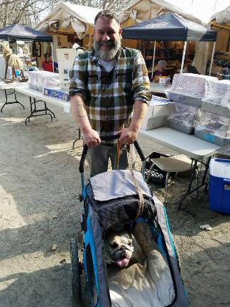 Robert Tagliapietra of Brooklyn, chauffeurs Maude the Bulldog around Wild West City on Saturday, while treasure hunting at B.A.R.K.S.' Semi-Annual Garage Sale.