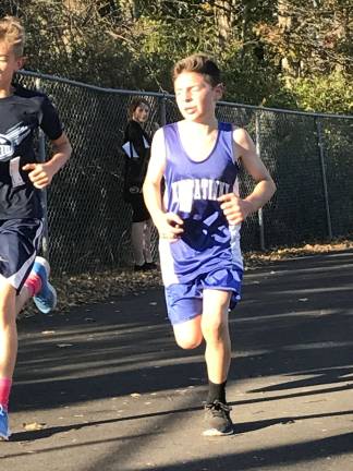 Ryan Espinosa, a seventh grade standout on Tooker's team, gives it his all during his race at the Invitational.