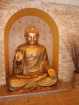 Photos by Karen Daley A giant, gloden Buddha welcomes guests to Wings Asian Fusion Bistro.