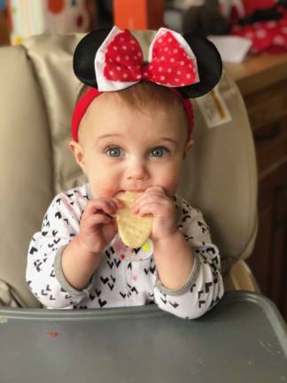 FIRST FOODS. CHARLOTTE EATING HER FIRST CHIP. Photo courtesy of Lynn.