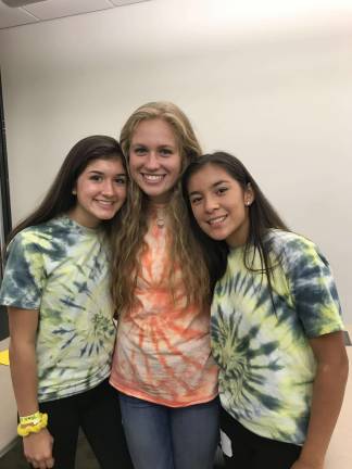 Grace Sander (center) introduced the conference to start the day. Teens involved in organizing the event wore tie dye shirts. Sander is surrounded by Valeria Molina and Kelsi Loewen. All three are juniors at Sparta High School.