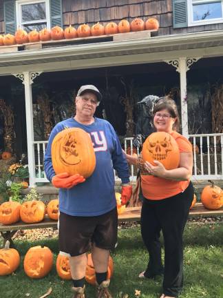 photo by laurie gordon Sara Bartlett and her husband, Mike Young, carve pumpkins galore each year to transform their home into “The Pumpkin House.”