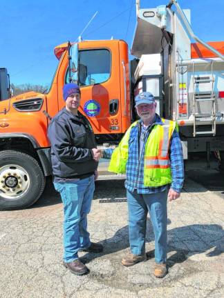 Scott House, left, director of the county Division of Public Works, shakes hands with Ernest Katzenstein.