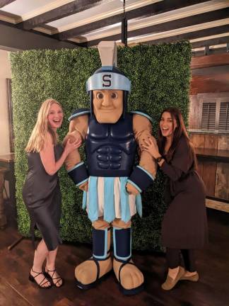 Nadia Hopper and Alexis Mongiello pose with the Sparta High School mascot, Sparty.