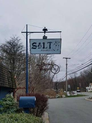 A bicycle adorns the sign outside Salt Gastropub in Byram, just a hint of the eclectic atmosphere inside the pub