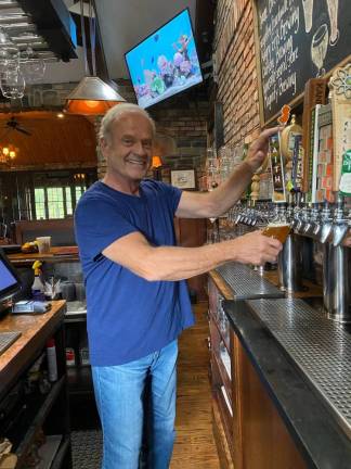 Grammer pours a beer at Mohawk House. Photo by Laurie Gordon.