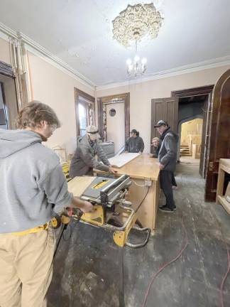 SCCC Students in the Building Construction Technology program are instructed by their professor on the proper use of the equipment.