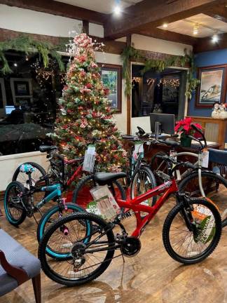 The Coldwell Banker Realty office in Sparta collected food and toys, including nine bicycles, for Project Self-Sufficiency. (Photo provided)