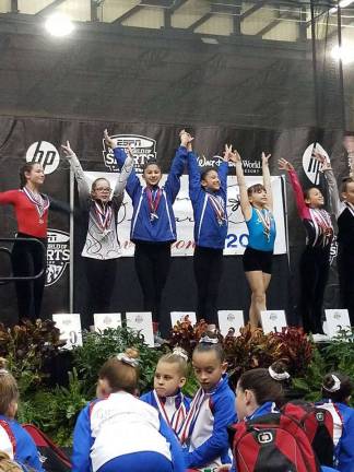 The two girls in blue at center: Ariana Begraft, on left, of Hampton, and Arianna Frank of Glenwood Photos provided by Giant Gymnastics