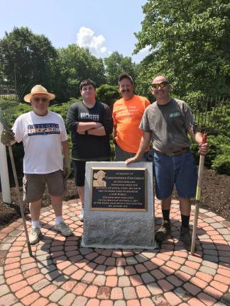 UNICO members Alfonso Caliendo, Glen Vetrano, and Ray Shupak along with Pope John rising senior Ethan Harby stand next to the Columbus monument following the clean-up and mulching of the garden areas. Photos provided