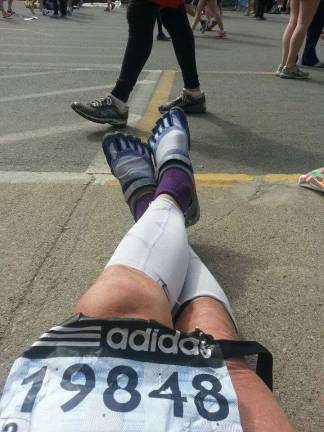 Photo by Karl Fenske Karl snaps a photo of his sneakers before running the Boston Marathon in 2013.