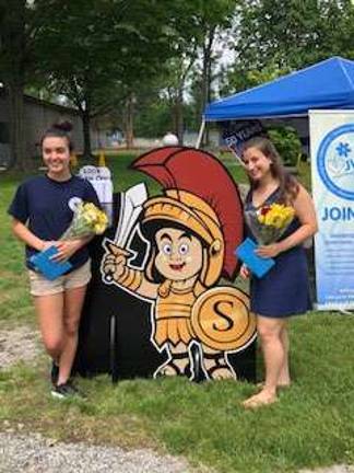 Jamie Rennie, on the left of Sparta Sam, and Adriana Purcell on the right, receive their scholarship awards at Sparta Day, June 2 Photos provided