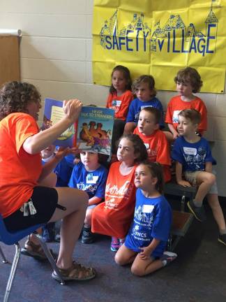 A group leader reads a book about stranger danger between safety presentations Photos provided by JWCS