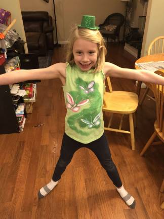 The jumping jack leprechaun. Madison doing her exercises to prepare for her mischief. Photo courtesy of Karen.