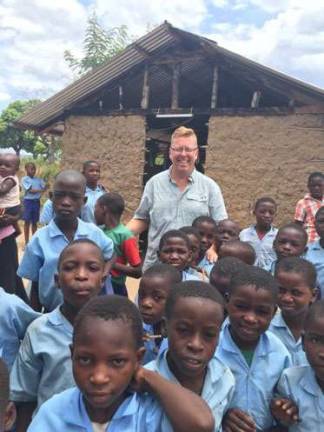 Pastor Doug Thuen of the Sparta Evangelical Free Church with South Sudanese children