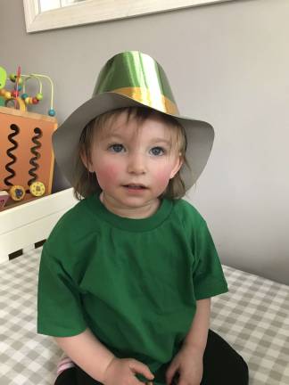 Grace in her leprechaun hat and Grace being her happy self