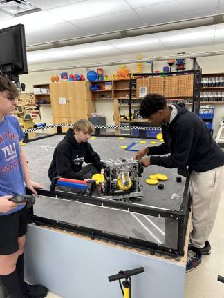 From left are members of Sparta High School robotics team 5249 Z “Artemis”: Nick Audino, who is driving the robot; Liam Askin, the engineer; and team captain Millen Duberry. (Photos by Carlos Davidson)