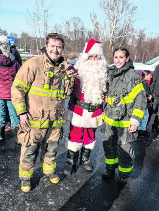 Harrison DaMico and Lucie Wolfson pose with Santa Claus.
