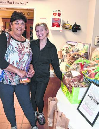 Shelley Space and Gabrielle Ahrens, both of Sparta, stand in front of the prize table.