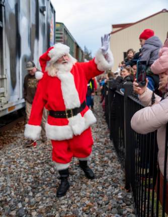 Santa waves to the crowd waiting for him Saturday, Dec. 9 at the Sparta Train Station. (Photos by Nancy Madacsi)