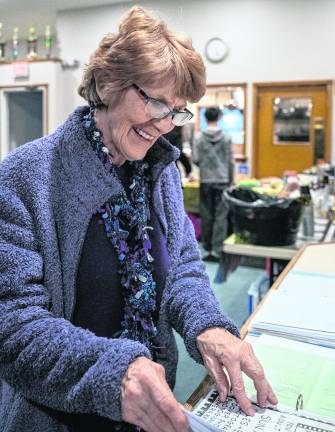 Wendy Stamer reviews club’s historical documents.