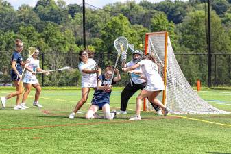 Mendham battles through a tight Sparta defense to fire off a shot in the first half of the NJSIAA North Jersey, Group 2 championship game Tuesday, June 10. The Spartans defeated Mendham, 8-4, then lost to Allentown, 6-5, in the Group 2 final Friday, June 13. (Photo by Lauren Clark)