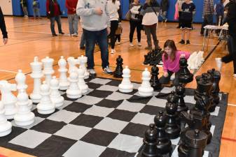 Joelle Morris of Sparta plays with a life-size chess set during the Sparta Winter Carnival on Saturday, Feb. 10 at Sparta Middle School. (Photo by Maria Kovic)