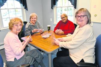 Joan Wills, Linda Fiedler, Gloria Diabo and Pat Kibildis, all of Sparta, play a card game.
