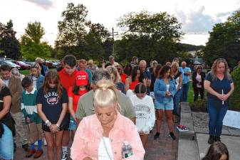 Residents bow their heads during a vigil Sunday, Sept. 14 in Sparta for Charlie Kirk, who was shot and killed Wednesday, Sept. 10 while speaking on a college campus in Utah. (Photos by Maria Kovic)