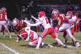<b>High Point ball carrier A.J. Sampson is tackled by Lenape Valley defender Chase Grant (52) in the first half of their game Friday, Oct. 10 in Sussex. The Wildcats won, 35-6. (Photos by George Leroy Hunter)</b>