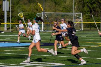 Uma Kowalski of Sparta (7) protects the ball from Makenna Thomas (20) and Abby Bonnema (2), both of Vernon. Her Spartan teammates Shea Cina, back left; Sophia Paolercio (18); and Katherine McCall (24) support Kowalski across the field.