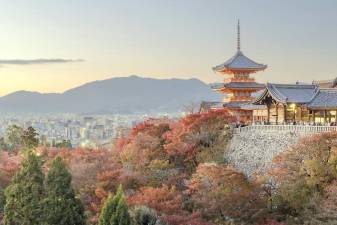 Autumn color at Kiyomizu-dera temple in Kyoto, Japan. Founded in the early Heian period, Kiyomizu-dera temple was founded in 778. It is famous for not having used a single nail in its construction. The temple is part of the Historic Monuments of Ancient Kyoto and is also a UNESCO World Heritage Site. (Photographer: Julian Elliott)