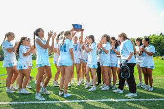 The Sparta High School girls lacrosse team poses with the trophy after defeating Mendham, 8-4, in the NJSIAA North Jersey, Group 2 championship game Tuesday, June 10. The team will face Allentown there in the Group 2 final Friday, June 13. (Photos by Lauren Clark)