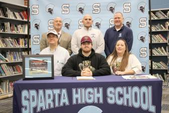 Sparta High School senior Hunter Peterson, seated center, will play football next fall at Kutztown (Pa.) University. Seated with him are his parents, Chris and Kim. Back row from left are Principal Ed Lazarra, head football coach Frank Marchiano and athletic director Steve Stoner. (Photo provided)