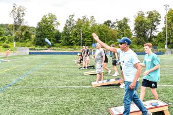 A participant tosses a bag in the fifth annual Cornhole Tournament, benefiting the Sparta Education Foundation, on Sunday, Aug. 24. (Photosby Maria Kovic)