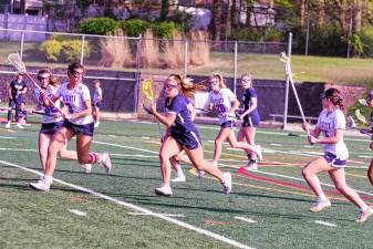 Pope John's Olivia Zywicki is on the move with the ball in the game against Lenape Valley on May 1. She scored one goal. The Lions lost, 8-7. (Photos by George Leroy Hunter)